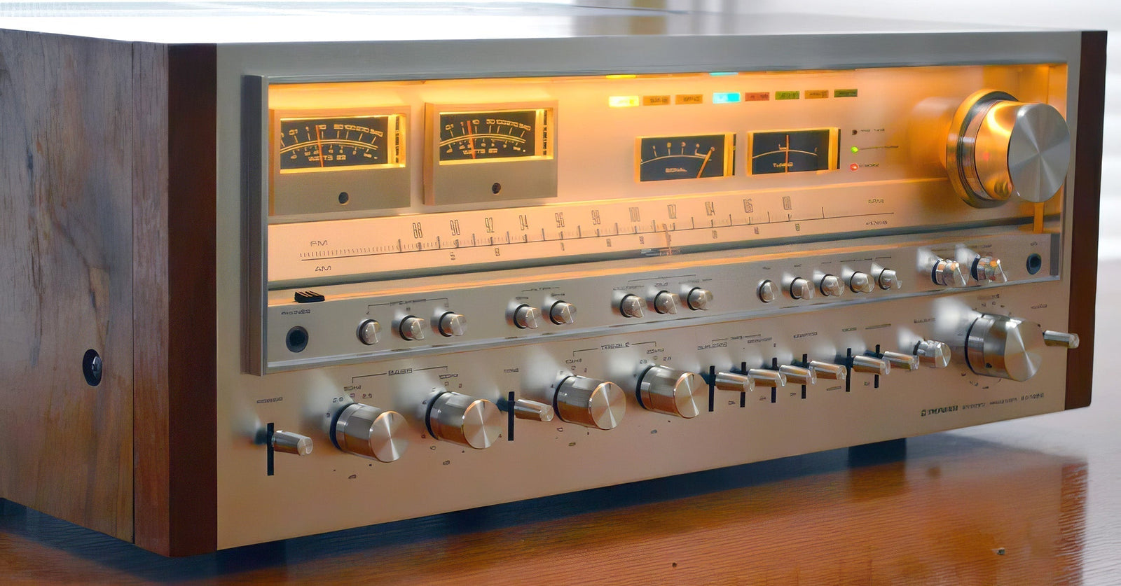 Pioneer SX-1980 vintage stereo receiver with glowing amber meters, brushed aluminum faceplate, and walnut veneer cabinet — king of 1970s receivers.